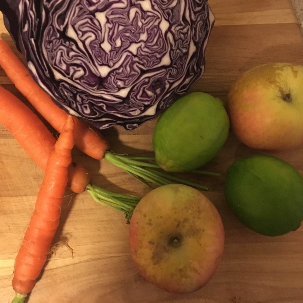 ingredients for salad: cabbage, carrots, limes, apples